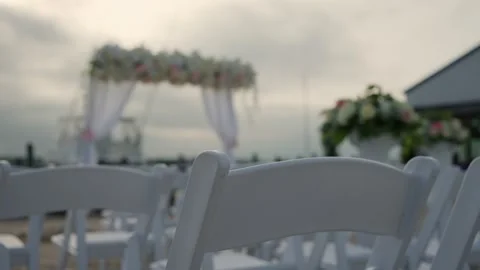 A Serene Beach Wedding Setup with Elegant Decor Elements and a Beautiful Scenic Stock Footage 314575420