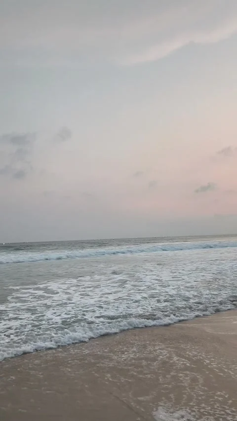 A Serene Beach with White Waves Lashing at Sunset Stock Footage 333497387
