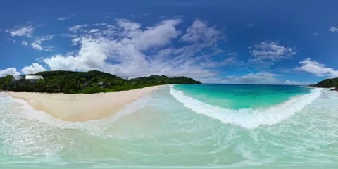 Serene beachfront with gentle waves and clear skies. Mahe, Seychelles. Stock Footage 301447502