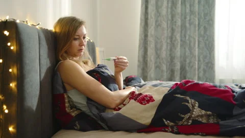 Serene Bedroom Scene: Blonde Checking Temperature, No Gifts Present. Stock Footage 259796553