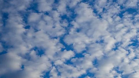 Serene blue sky filled with pattern of white fluffy clouds. Natural cloudscap Photos