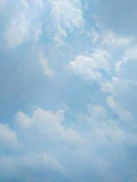 Serene Blue Sky with Fluffy Clouds Stock Photos