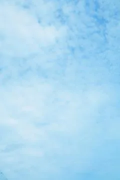 Serene Blue Sky with Soft Clouds, a Peaceful Weather Background Stock Photos