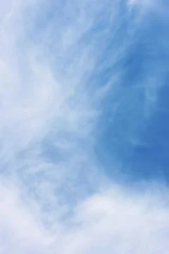 Serene Blue Sky with Whimsical Cloud Patterns for Tranquil Designs Stock Photos