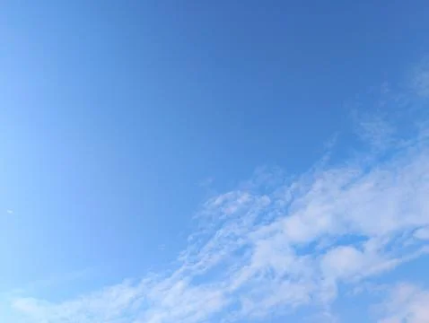 Serene Blue Sky with Wispy Clouds Stock Photos