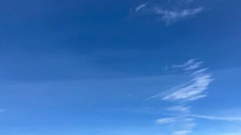 Serene Blue Sky with Wispy Clouds Stock Photos