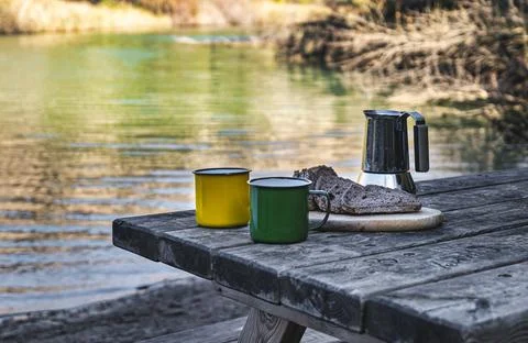Serene Breakfast: Bread and Coffee on the Quiet Bank. Stock Photos