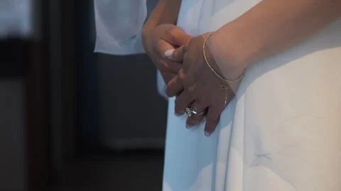 Serene Bride With Clasped Hands, Elegant Bride Waits Patiently With Gentle Touch Stock Footage 323772846