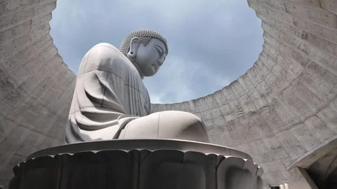 Serene Buddha Statue Surrounded by Stone Architecture Stock Footage 313834998