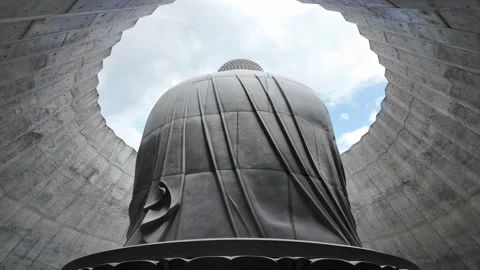 Serene Buddha Statue Under a Cloudy Sky Stock Footage 315469193