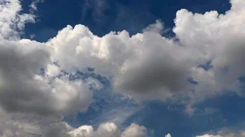 Serene cloudscape featuring a vibrant blue sky interspersed with patches of f Фото