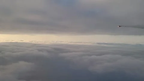 Serene Cloudscape View from Airplane Window Flying Above the Sea of Clouds Video stock 323159332