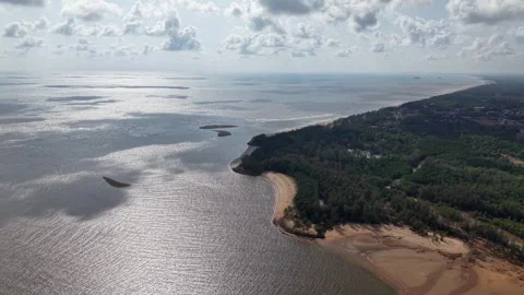 Serene coast meets calm waters under scattered clouds Stock-Footage 337726164