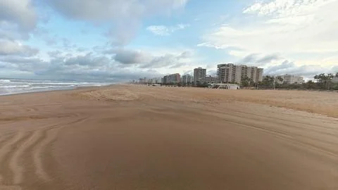 A Serene Coastal Beach View Showcasing Beautiful Coastal Buildings Beneath .. Stock Photos
