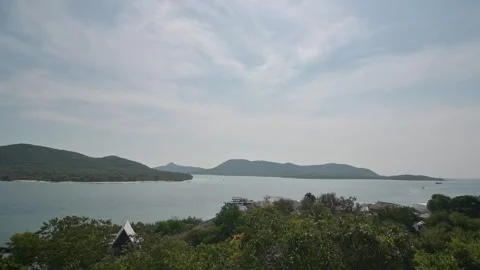 Serene Coastal Landscape with Island and Clouds in the Sky Stock Footage 296480341
