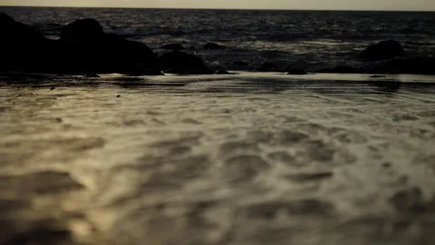 A Serene Coastal Scene: Gentle Waves Lapping Against the Shore, with a Beautiful Stock Footage 310061353