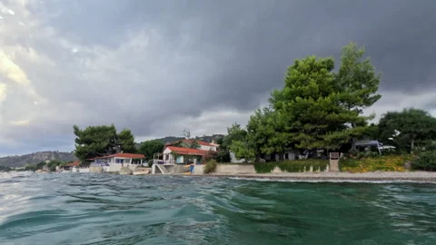 Serene Coastal Scene Under Dramatic Cloudy Sky Stock Footage 321185177