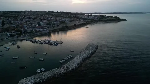 Serene Coastal View at Dusk Featuring Boats and Quaint Town Along the Shoreline Stock Footage 294996434