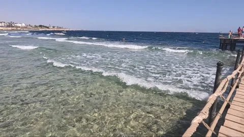 A Serene Coastal View Featuring Gentle Waves and Clear Waters, Highlighting a Video stock 330100162