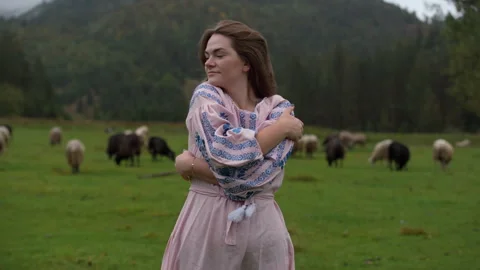 Serene countryside scene with dancing shepherdess and grazing sheep Stock Footage 325561109