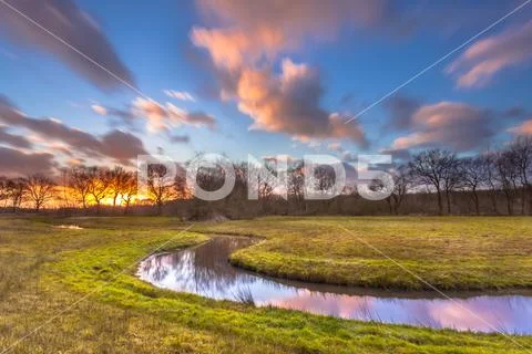 Serene Creek with Blurred Clouds Stock Photos