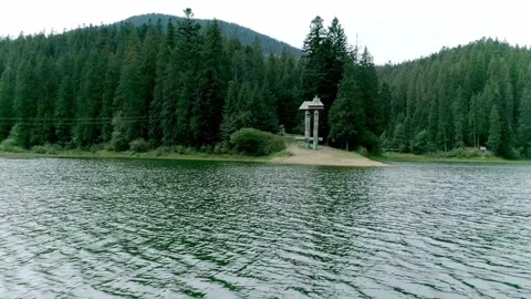 Serene drone view over mountain lake with sandy beach Stock Footage 326937059
