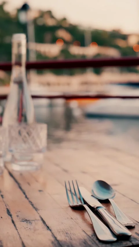 A serene evening dining experience awaits at an outdoor restaurant by sea w.. Stock Footage 339641331
