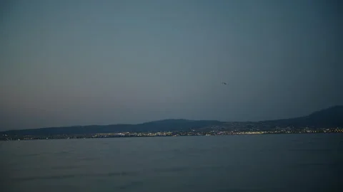 Serene Evening With Distant Airplane Over Calm Waters Stock Footage 263264851