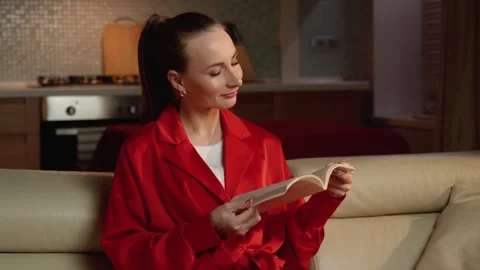 Serene Evening Reading Session in a Cozy Living Room Setting Stock-Footage 265215092