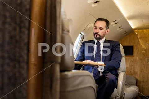 Serene gentleman using private jet Stock Photos