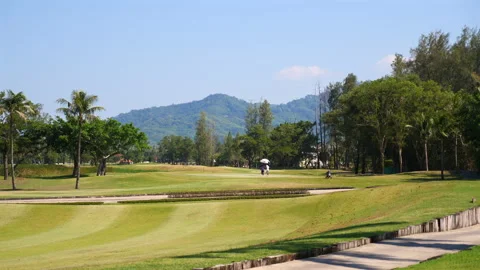 Serene golf course landscape with golfer in distance, tropical Video stock 274046578
