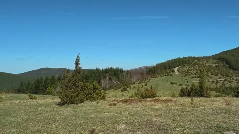 Serene hills roll under clear blue skies. Balkan, Eastern Europe, POV Video stock 333442709