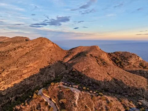 Serene hillside surrounded by nature, mighty promontory overlooking tranquil Stock Photos