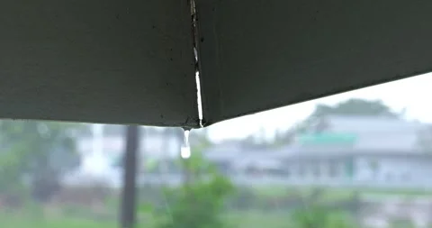 Serene indoor view of rain falling outside seen through partially closed window Stock Footage 337784883