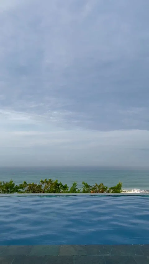 Serene Infinity Pool Overlooking the Calm Ocean and Cloudy Sky Stock Footage 340256645