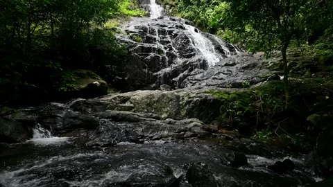 Serene Khot Nuea Waterfall Surrounded by Lush Greenery in Saraburi Stock Footage 315490589