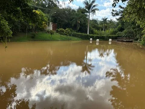 Serene lagoon with reflections of clouds Stock Photos