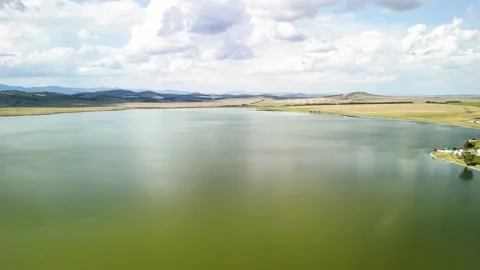 A serene lake against the backdrop of a mountain range. Stock Footage 314594498