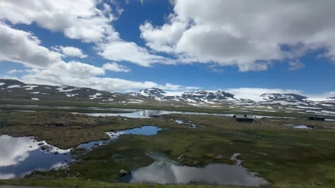 A serene lake captures the stunning reflection of surrounding mountains Stock-Footage 314077130