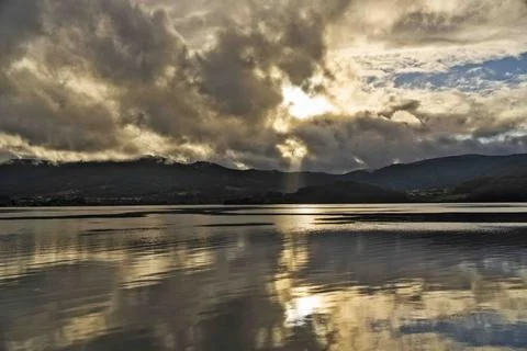 Serene Lake Landscape with Dramatic Clouds Stock Photos