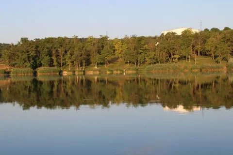Serene Lake Reflection with Lush Trees Stock Photos