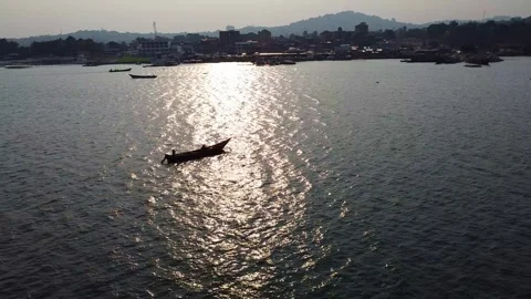 Serene Lake Scene Featuring a Small Boat with Distant Shoreline and Hazy Sky Stock Footage 314472895