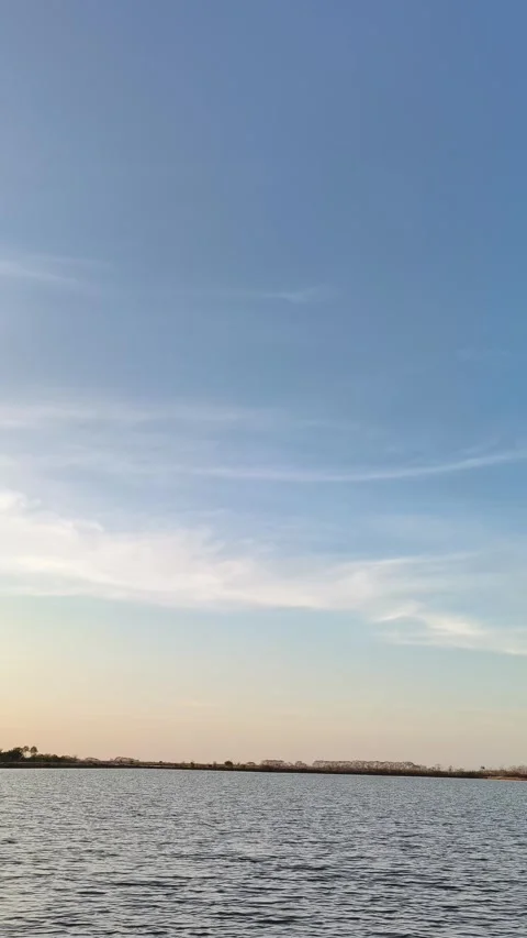 Serene Lake Sunset Landscape with Soft Clouds Vertical Stock Footage 340489908