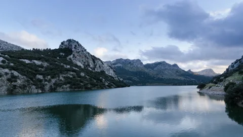 Serene Lake Surrounded by Mountains Stock Footage 303152985