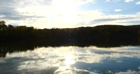 Serene Lake Surrounded by Trees and Clouds Video stock 262401457