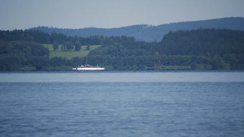 Serene lake view with a distant ferry gliding across the Vltava Reseroir Stock Footage 318061263