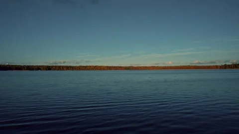 Serene lake view with distant forest horizon Stock Footage 301125242