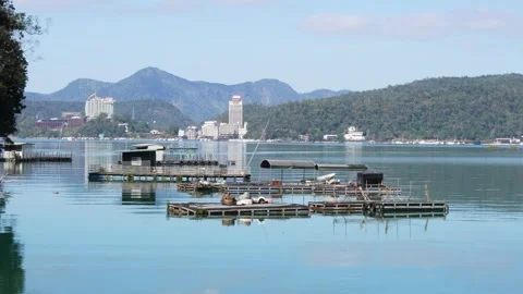 Serene Lake View with Floating Docks and Distant Hills Stock Footage 268908897