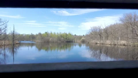 Serene lake view through a narrow opening Stock Footage 324315966