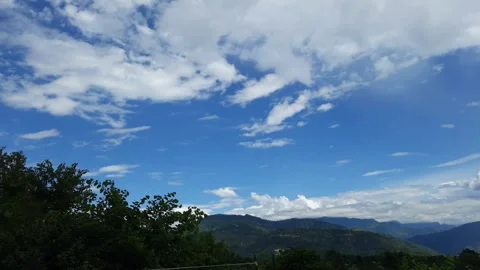  "Serene Landscape: Clouds, Trees, and Sky in Harmony"   Video stock 303157488